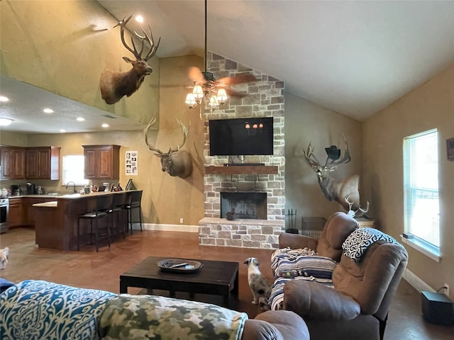 living room featuring ceiling fan, concrete floors, vaulted ceiling, and a fireplace