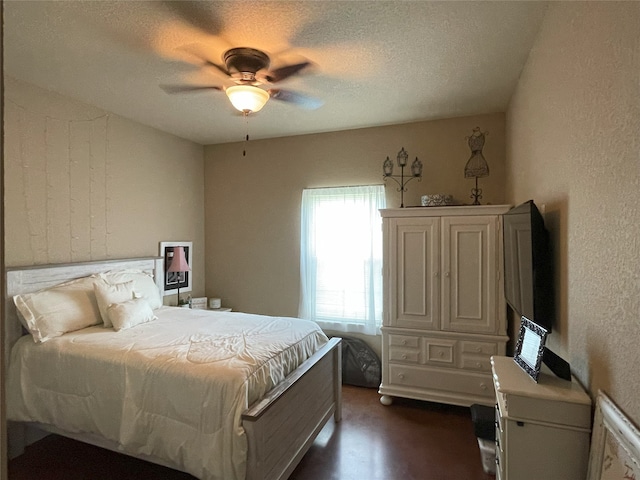 bedroom with a textured ceiling and ceiling fan