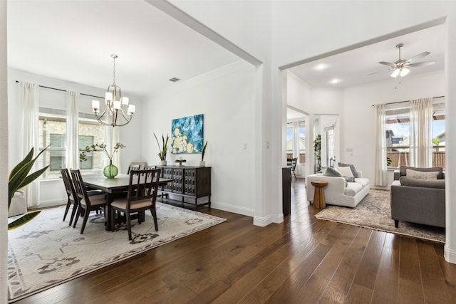 dining space featuring ceiling fan with notable chandelier and wood-type flooring