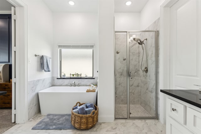 bathroom with tile patterned flooring, separate shower and tub, and vanity