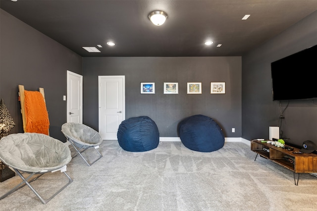 sitting room featuring light colored carpet