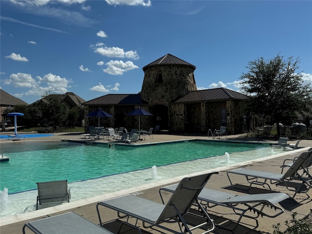 view of pool with pool water feature and a patio area