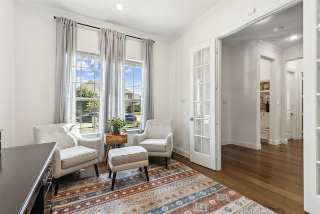 living area with french doors, dark wood-type flooring, and ornamental molding