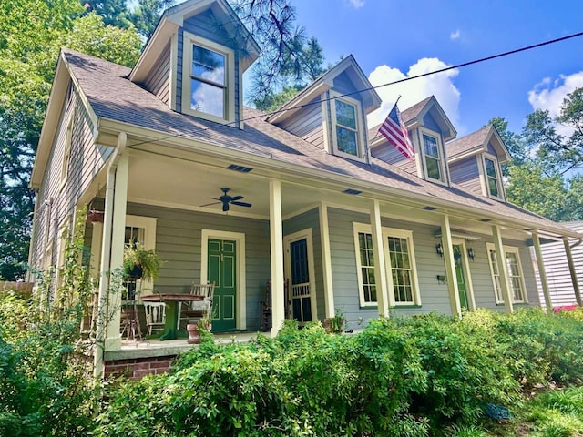 cape cod home with ceiling fan and covered porch