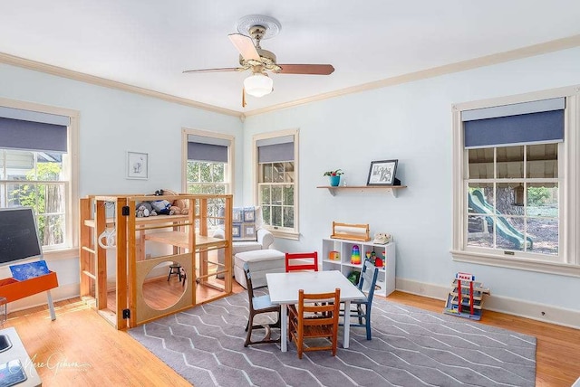 dining space featuring ceiling fan, crown molding, and hardwood / wood-style flooring