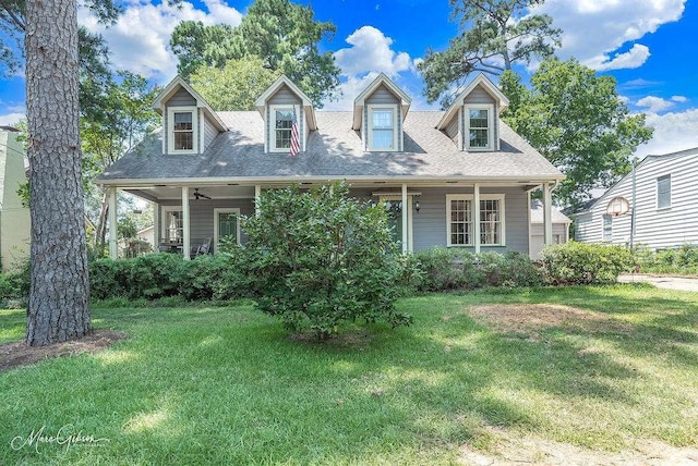 cape cod house with ceiling fan and a front lawn