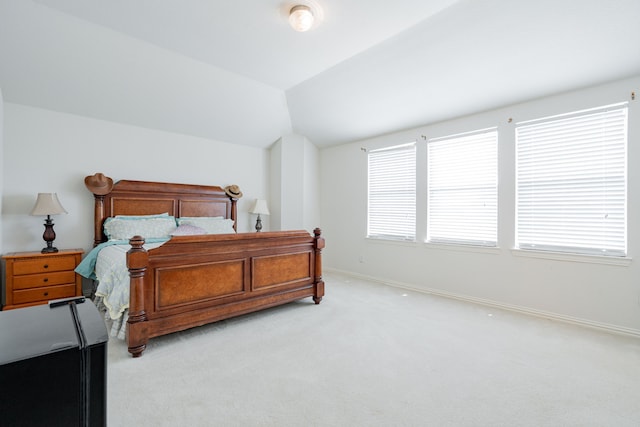 carpeted bedroom with lofted ceiling