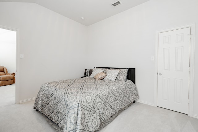 carpeted bedroom with lofted ceiling