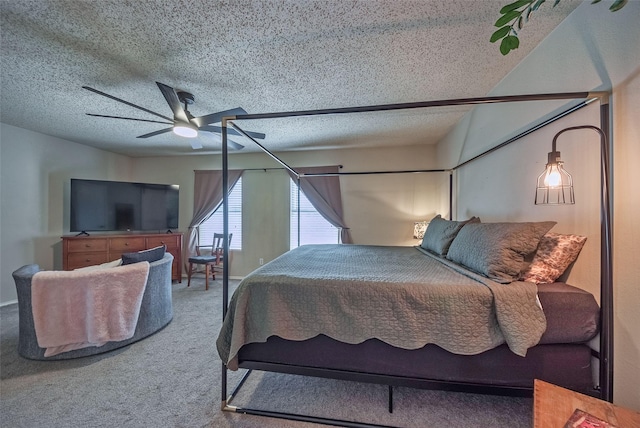 carpeted bedroom featuring ceiling fan and a textured ceiling