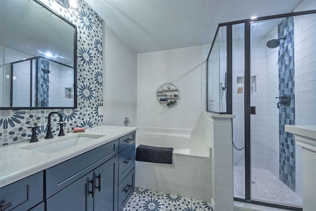 full bath featuring a stall shower, tile patterned flooring, vanity, and a bath