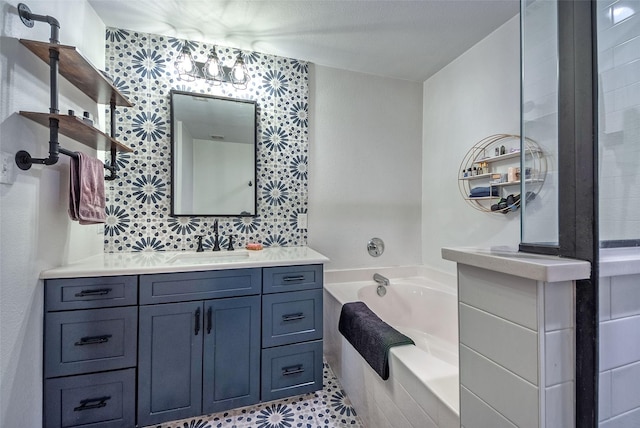 bathroom featuring a garden tub, vanity, and wallpapered walls