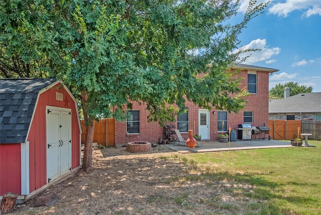 exterior space with a fire pit, a patio, a storage unit, and a fenced backyard