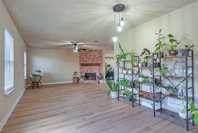 sunroom / solarium with visible vents, a fireplace, a ceiling fan, and a healthy amount of sunlight