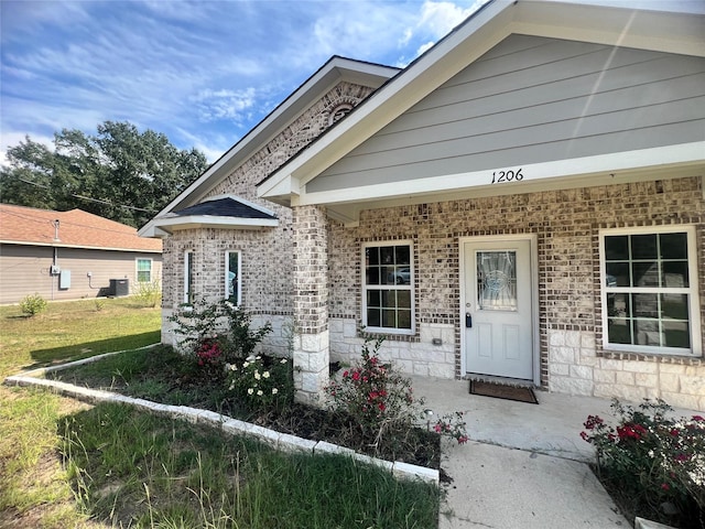 view of front of home featuring covered porch, central air condition unit, and a front lawn