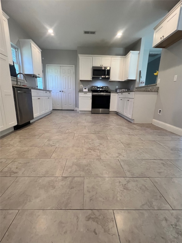 kitchen with stone counters, ceiling fan with notable chandelier, decorative light fixtures, and white cabinetry