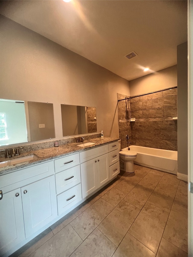 full bathroom with vanity, toilet, and tiled shower / bath