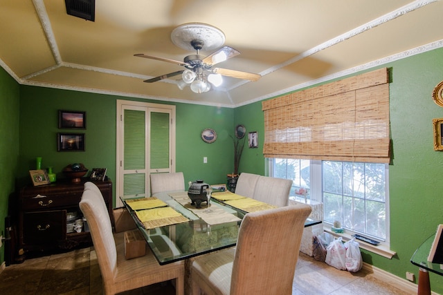 dining area featuring tile patterned flooring, lofted ceiling, ornamental molding, and ceiling fan