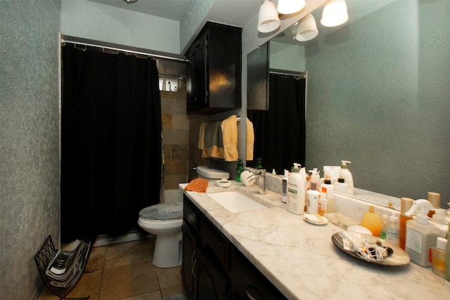 bathroom with tile patterned flooring, walk in shower, vanity, and toilet