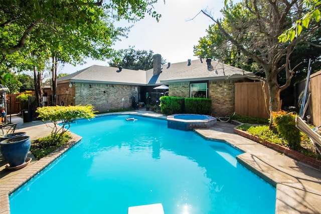 view of pool with a patio and an in ground hot tub