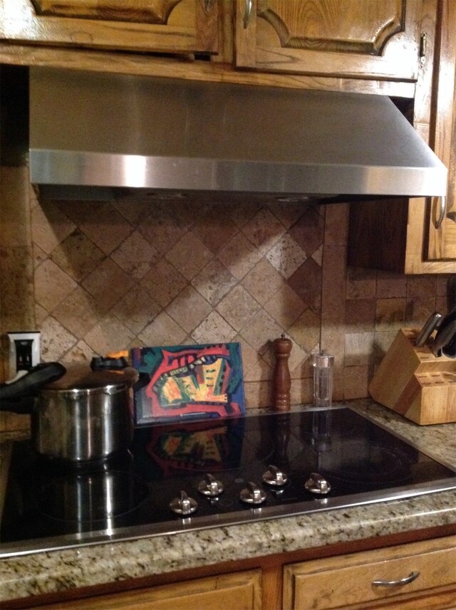 kitchen featuring black electric cooktop and decorative backsplash