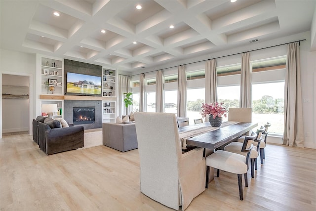 dining space with beamed ceiling, light wood finished floors, and coffered ceiling