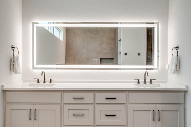 full bathroom with double vanity and a sink