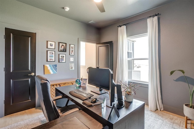 office space featuring visible vents, baseboards, and a ceiling fan