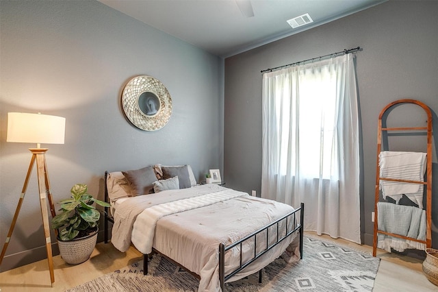 bedroom with visible vents, light wood-style floors, and ceiling fan