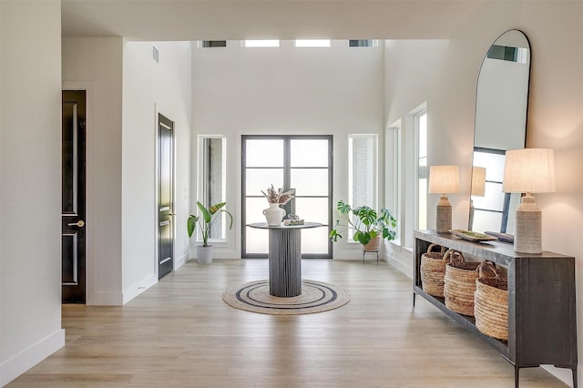 interior space with visible vents, light wood-style floors, and a healthy amount of sunlight