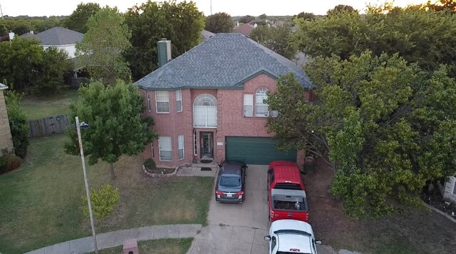 view of front of house with a garage and a front lawn