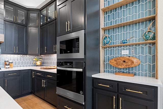 kitchen with stainless steel appliances and backsplash