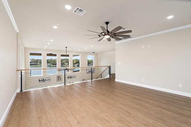 unfurnished living room featuring ornamental molding, light hardwood / wood-style flooring, and ceiling fan