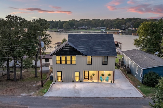 modern farmhouse style home featuring a water view