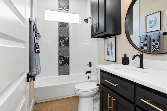 full bathroom with wood-type flooring, vanity, toilet, and tiled shower / bath combo