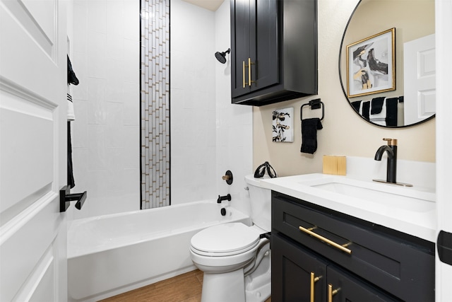 full bathroom with hardwood / wood-style floors, vanity, toilet, and tiled shower / bath combo