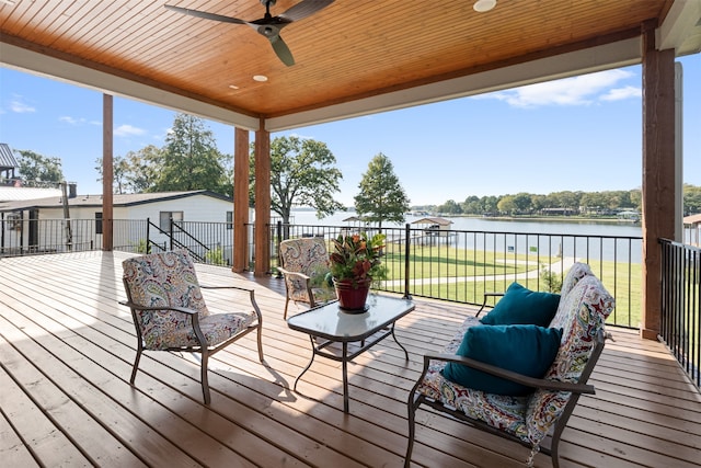 wooden deck featuring a water view and ceiling fan