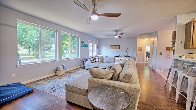 living room with hardwood / wood-style flooring and ceiling fan