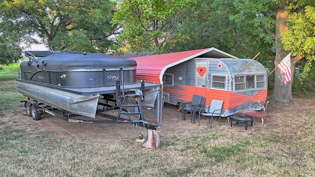 exterior space featuring an outdoor structure and a lawn