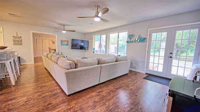 living room featuring ceiling fan, dark wood-type flooring, and french doors