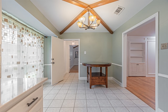 dining room featuring light wood-type flooring, lofted ceiling, and a chandelier