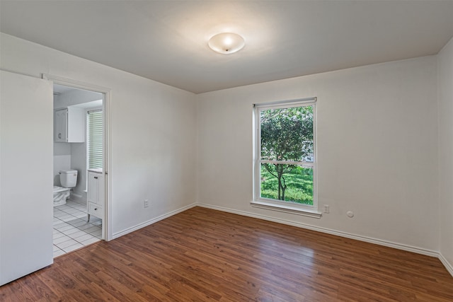 empty room with hardwood / wood-style floors