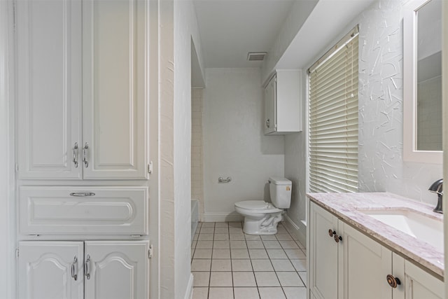 bathroom featuring vanity, toilet, and tile patterned flooring