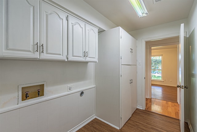 laundry room with washer hookup, cabinets, hookup for an electric dryer, and dark hardwood / wood-style floors