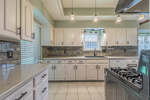 kitchen featuring pendant lighting, white cabinetry, sink, and decorative backsplash