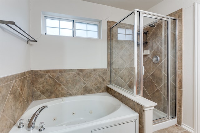 bathroom featuring shower with separate bathtub