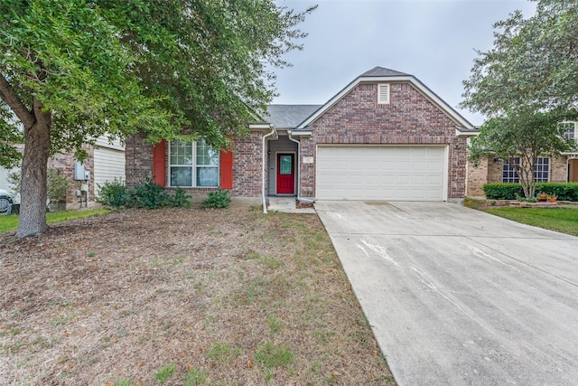 ranch-style house with brick siding, concrete driveway, and a garage