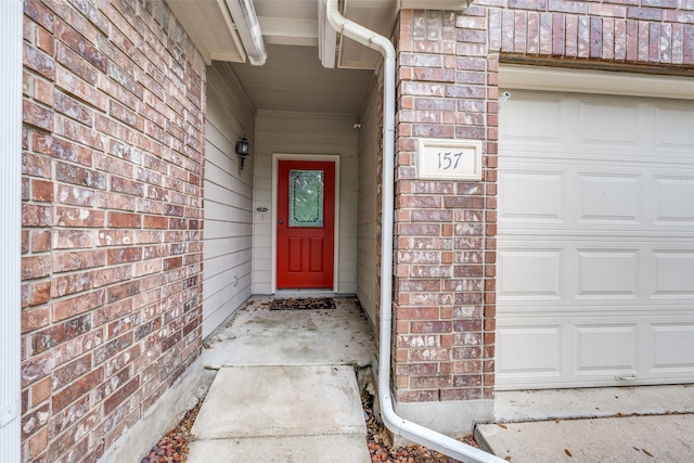 view of exterior entry with a garage