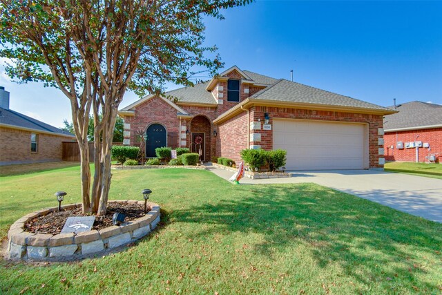 view of front of home featuring a garage and a front lawn