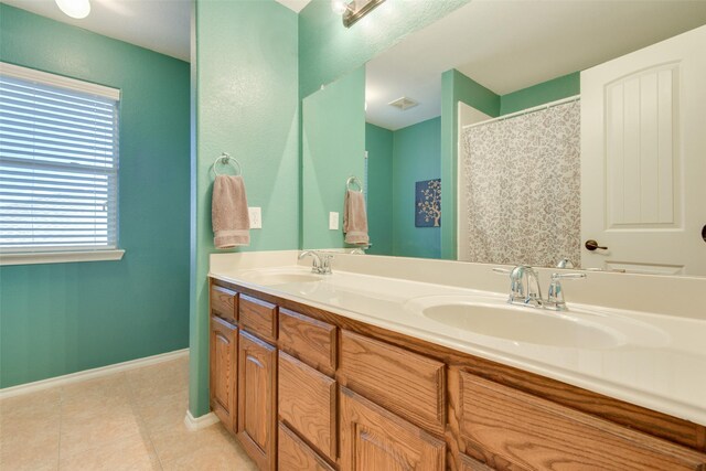 bathroom featuring vanity, a shower with shower curtain, and tile patterned flooring