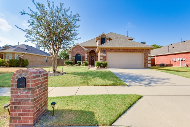 view of front of home featuring a garage, a front lawn, and central air condition unit